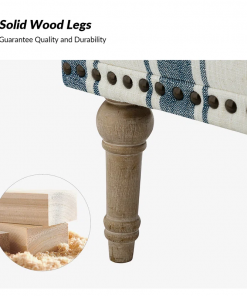 arching armchair with solid wood legs and nailhead trim