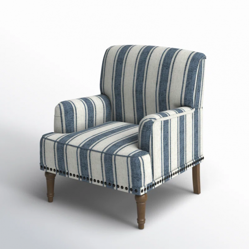 arching armchair with solid wood legs and nailhead trim