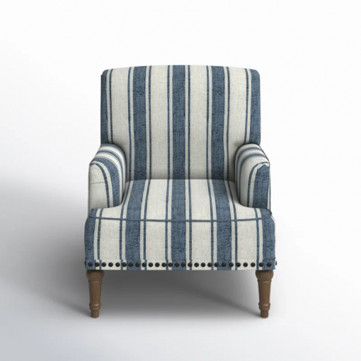 arching armchair with solid wood legs and nailhead trim