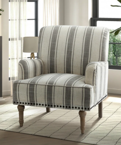 arching armchair with solid wood legs and nailhead trim