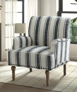 arching armchair with solid wood legs and nailhead trim