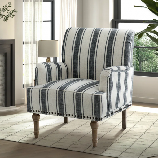 arching armchair with solid wood legs and nailhead trim