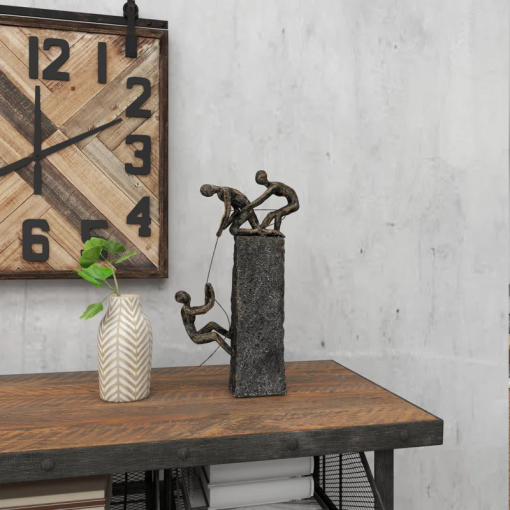 gray polystone people climbing decorative sculpture with bronze detailing, 7" x 3" x 17"