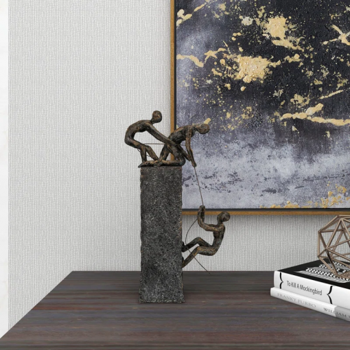 gray polystone people climbing decorative sculpture with bronze detailing, 7" x 3" x 17"